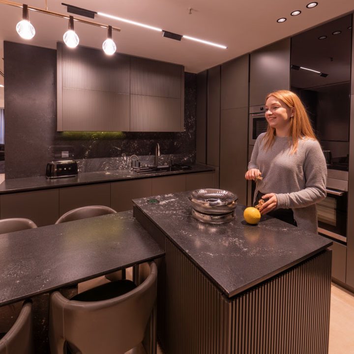 woman laughing in the kitchen